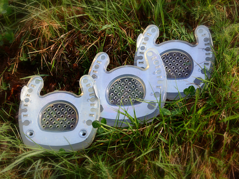 open toe horseshoe, open toe horseshoe with clips and open toe shoe with clips and threaded inserts lie in the gras