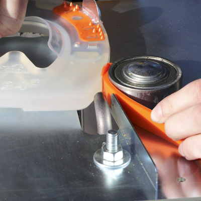 A farrier welding a colored strip onto a composite horseshoe.