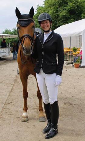 dressage horse with glue-on composite horseshoes and rider on a show